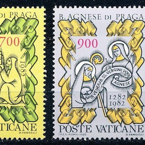 May include: Two Vatican postage stamps featuring illustrations of Saint Agnes of Prague. The stamps are yellow and gray, with green and gold decorative borders. The stamps include the text "POSTE VATICANE" and the years 1282 and 1982.
