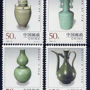 May include: A sheet of four Chinese postage stamps featuring celadon pottery. The stamps showcase various ceramic pieces, including a lidded jar, a vase with handles, a double-gourd vase, and a handled pitcher. Each stamp has a denomination and the word "CHINA".