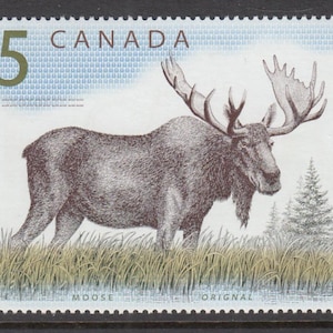 May include: A rectangular postage stamp featuring a detailed brown illustration of a moose standing in tall grass with pine trees in the background. The text $5 CANADA is printed in the upper left, and MOOSE ORIGNAL is printed at the bottom.