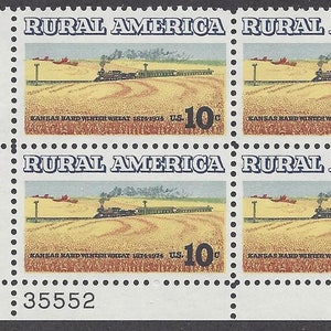 May include: A sheet of four 10-cent postage stamps featuring a train traveling through a field of wheat. The stamps are titled "Rural America" and feature the text "Kansas Hard Winter Wheat 1874-1974".