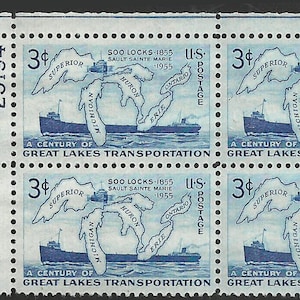 May include: A sheet of four 3-cent U.S. postage stamps. Each stamp features a blue illustration of the Great Lakes with a ship, and text that reads "A Century of Great Lakes Transportation."
