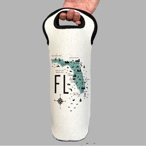 May include: White wine bottle cooler with a black handle and a map of Florida with the text "FL" printed on it.