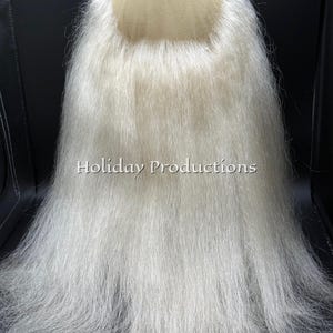 May include: A long, white beard with a mesh cap base. The beard is made of long, flowing, white fibers. The text "Holiday Productions" is printed on the beard.