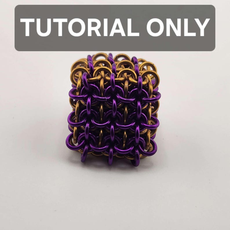 May include: A square-shaped chainmaille cube constructed from interlocking metallic rings in alternating purple and bronze colors. The text TUTORIAL ONLY is displayed in white letters on a dark gray rectangular background above the cube.