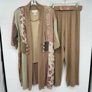 May include: A three-piece set consisting of a long-sleeved patchwork jacket, a solid tan tank top, and matching tan trousers. The jacket features floral patterns in muted pink, green, and brown tones with three decorative gold-toned toggle buttons.