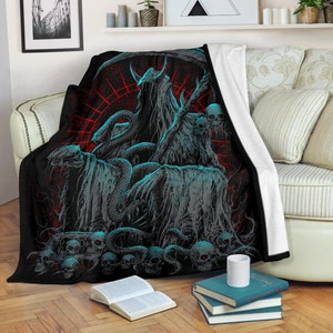 May include: Black and blue fleece throw blanket with a graphic of a hooded figure, a snake, and skulls. The background is red and black.
