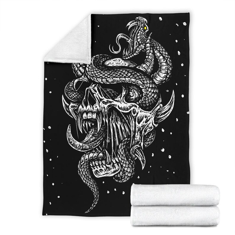 May include: Black and white illustration of a skull with a snake wrapped around it. The skull has a large, open mouth with sharp teeth and a long, pointed tongue. The snake has a detailed, scaly texture and is coiled around the skull's head. The background is black with white dots.