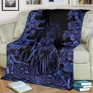 May include: A dark purple and black fleece blanket with a gothic design featuring a horned figure surrounded by demonic figures. The blanket is soft and plush, perfect for adding a touch of darkness to any room.