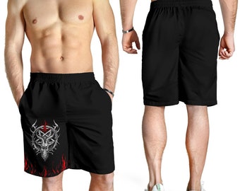 Puede incluir: Pantalones cortos deportivos negros con un gráfico rojo y blanco de una cabeza de cabra con cuernos y un pentagrama. El gráfico está rodeado de llamas.
