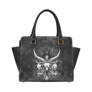 May include: Black leather handbag with a white graphic of a horned skull and crossbones on a distressed background.