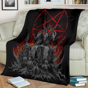 May include: Black and red fleece blanket with a graphic of a horned demon figure in a pentagram surrounded by flames.