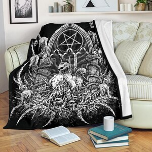 May include: Black and white gothic style throw blanket featuring a pentagram, skulls, and snakes. The blanket has a soft, plush feel and is perfect for adding a touch of darkness to any room.