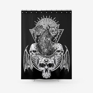 May include: Black and white illustration of a cat with wings sitting on top of three skulls. The cat is surrounded by a geometric design and a sunburst.