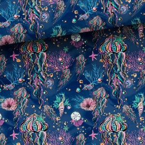 Può includere: Uno schema senza cuciture con meduse rosa e blu con accenti di glitter dorati su uno sfondo blu scuro. Lo schema include anche coralli, conchiglie e stelle marine.