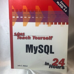 May include: A red, white, and blue book titled "Sams Teach Yourself MySQL in 24 Hours" by Julie C. Meloni. The book cover features a graphic design of arrows pointing to the right and the text "Covers MySQL 4.0".