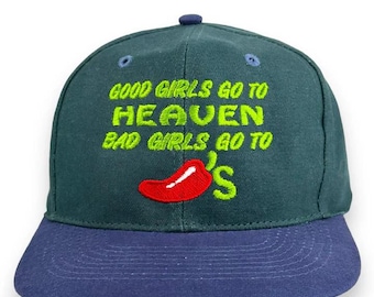 May include: A baseball cap with a dark teal crown and a navy blue brim. The cap features embroidered text in neon green that reads "GOOD GIRLS GO TO HEAVEN BAD GIRLS GO TO" with a red chili pepper graphic and the letter "S".
