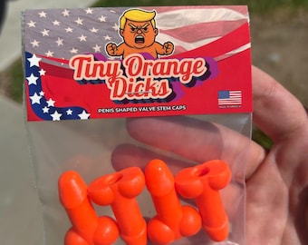 May include: A clear plastic bag containing four orange penis-shaped valve stem caps. The packaging features the text "Tiny Orange Dicks" with an illustration of a cartoon figure and the American flag.