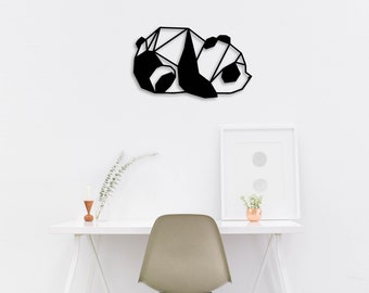 May include: Black and white geometric panda wall decor. The panda is in a sleeping position with its head resting on its paws. The decor is made of metal and has a modern, minimalist style.