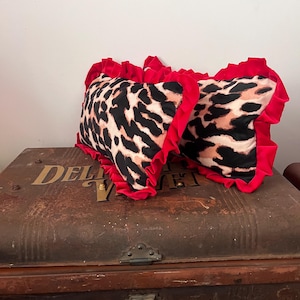 Two Delightfully  Velvet leopard print and red frill velvet cushions
