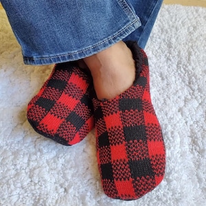 May include: Red and black plaid slippers with a fuzzy lining.