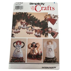 May include: Simplicity Crafts pattern 7549 for one size ornaments. The package displays various fabric angel and animal figures with wings, including designs with stars and stripes, gingham patterns, and lace accents for holiday decor.