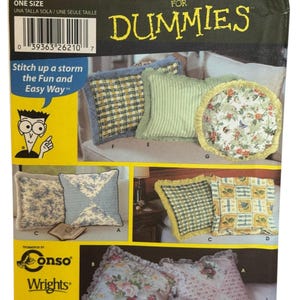 May include: Simplicity sewing pattern for pillows. The pattern includes various pillow designs with floral, striped, and checkered patterns. The text "Sewing Patterns for Dummies" is visible.
