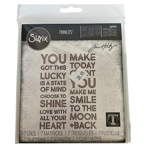 May include: Sizzix Thinlits die set featuring motivational quotes such as "You Make Today Lucky" and "Choose to Shine." The package contains 7 dies, 7 matrices, and other elements. The design has a distressed, textured background.