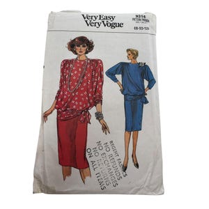 May include: A vintage Very Easy Very Vogue sewing pattern packet. The packet features illustrations of two women's outfits. One woman is wearing a red outfit with white accents, and the other is wearing a blue outfit. The packet has text that reads "REGENT FABRICS".