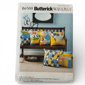 May include: A Butterick Waverly sewing pattern envelope with a bench and several decorative pillows. The pillows have colorful geometric and floral patterns in blue, yellow, orange, and green. The envelope has the text "B6500 Butterick Waverly".