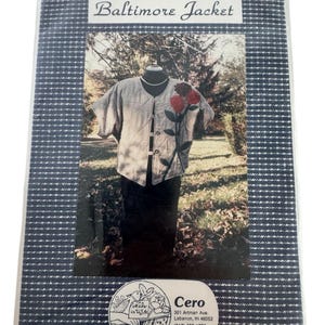 May include: A packaged sewing pattern for a "Baltimore Jacket" with a navy and white checked pattern. The image on the pattern shows a jacket with red floral embroidery. The package also includes the "Cero" logo and address.