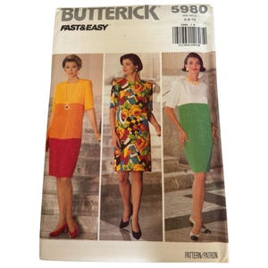 May include: A Butterick sewing pattern titled "5980" with the words "Fast & Easy" at the top. The pattern features three different dress designs, each modeled by a woman. The dresses are in various colors and patterns.