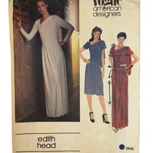 May include: Vintage Vogue American Designers sewing pattern featuring three dress designs. The cover shows a woman in a white dress and illustrations of two other dresses in blue and red. The pattern is by Edith Head, pattern number 2646.