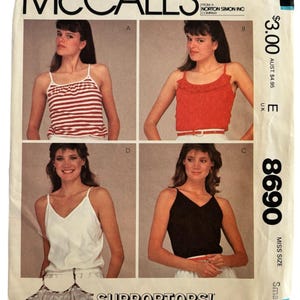 May include: Vintage McCall's sewing pattern envelope featuring four different Supportops! tank top designs. The envelope displays images of the tank tops in red, white, and black. The pattern is for stretch knits and is a Misses Small size.