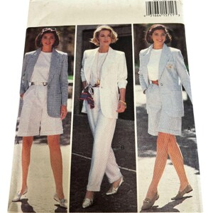 May include: A vintage Butterick sewing pattern envelope featuring three women modeling suits. The suits include blazers, shorts, and pants in white, blue, and patterned fabrics. The envelope has the number 6651 and the Butterick logo.