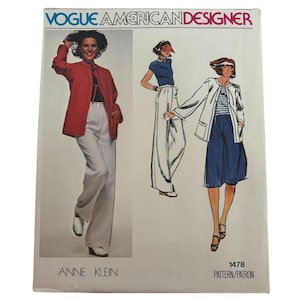 May include: Vogue American Designer sewing pattern 1478 by Anne Klein. The envelope features a photograph and illustrations of a jacket with a tie closure and pockets, paired with wide-leg trousers or a skirt. The text includes the brand name.