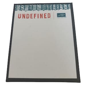 May include: A rectangular notepad with a dark gray border. The top edge features a teal and white geometric pattern. The word "UNDEFINED" is printed in red, with the Stampin' Up! logo on the right.