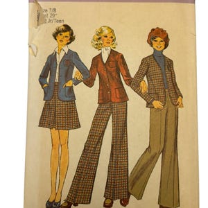 May include: Vintage Simplicity sewing pattern, number 6619, featuring illustrations of three figures in 1970s-style outfits. The outfits include blazers, skirts, and flared pants in plaid and solid colors. The pattern is for size 7/8 and Jr/Teen.