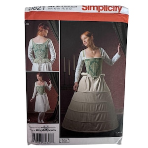 May include: A Simplicity sewing pattern envelope 2621 featuring a green damask corset with a white long-sleeved top and a full skirt. The package displays sizing information for US 16-24, EUR 42-50, and FR 44-52, with images showing the garment.