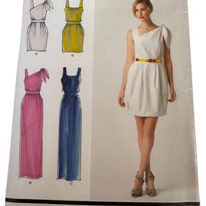 May include: A Simplicity sewing pattern featuring Cynthia Rowley designs. The pattern includes illustrations of various dress styles in white, yellow, pink, and blue. The model in the image wears a white dress with a yellow belt. The pattern's size range is 32-42.