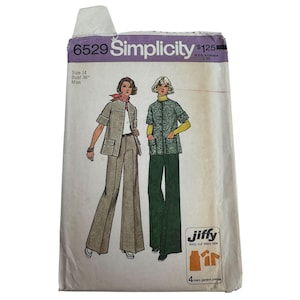 Könnte beinhalten: Vintage Simplicity Schnittmuster, Größe 14, mit Illustrationen von Hosenanzügen für Damen. Das Muster enthält eine Jacke und eine Hose mit weitem Bein. Die Verpackung trägt den Text "6529 Simplicity" und "Jiffy easy cut-easy sew".