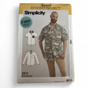 May include: A Simplicity Apparel Sewing Project pattern envelope, model CS9157, featuring a short-sleeve button-down shirt with a tropical print. The envelope displays technical line drawings for two shirt styles and a photograph of the shirt.