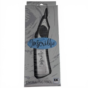 May include: An Inscriblio engraving tool packaged in a gray box with a blue oval logo. The tool is silver and black with a pointed tip. The packaging features the text Inscriblio and ENGRAVING TOOL in black lettering, along with the EK Success logo.