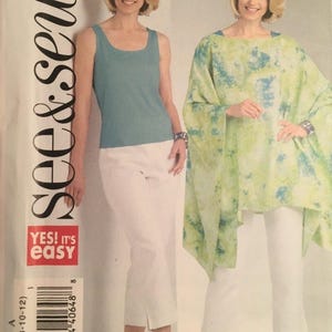 May include: A sewing pattern package showing two women in different outfits. One wears a teal vest top and white capri trousers, the other a green and blue patterned poncho and white capri trousers. The package has the text "see & sew" and "YES! It's easy".