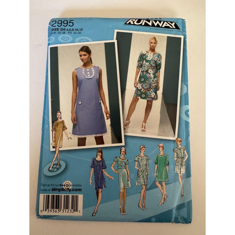May include: A Simplicity Project Runway sewing pattern envelope 2995, size D5 4, 6, 8, 10, 12. The blue packaging displays illustrations and photographs of various dress designs, including a blue polka dot dress with white buttons and a floral print dress.