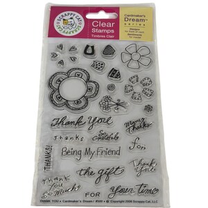 May include: A set of clear stamps by Scrappy Cat in the Cardmaker's Dream series. The sheet includes various floral shapes, patterns, and sentiments such as Thank You, Many Thanks, So Grateful, Being My Friend, and the gift for your time.