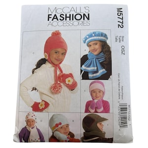 May include: McCall's Fashion Accessories pattern M5772. The pattern features various children's hat and mitten sets. The hats include a pink pom-pom hat, a blue beret, a pink hood, and a green cap with a visor. The mittens have flower accents.