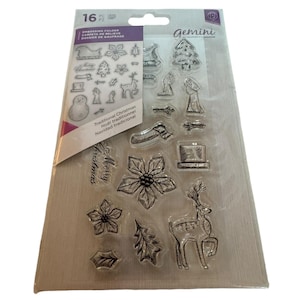 May include: A clear plastic sheet with 16 Christmas themed stamps. The stamps include a snowman, a reindeer, a Christmas tree, a poinsettia, a stocking, a hat, and the words "Merry Christmas".