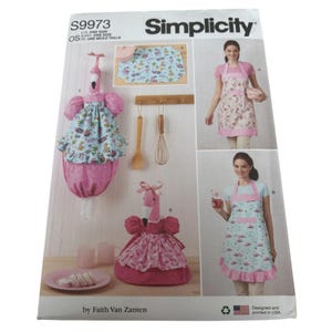 May include: Simplicity sewing pattern S9973 for a flamingo-themed apron and bag. The pattern includes instructions for making a pink flamingo-shaped bag with a ruffled skirt and a matching apron with a pink ruffle trim. The pattern is designed and printed in the USA.