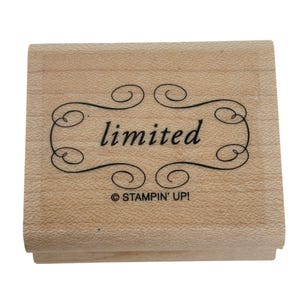 May include: A wooden stamp with the word "limited" in black script within a decorative black border. The stamp also includes the text "© STAMPIN' UP!" at the bottom.