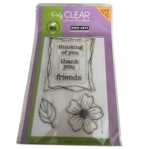 May include: A Hero Arts Poly CLEAR stamp set in original packaging. The set includes a rectangular frame stamp with the text thinking of you, thank you, and friends, plus a leaf and a flower stamp. The package measures 4 inches by 6 inches.